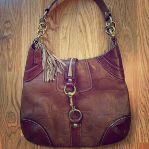 Tan Coach mid-size shoulder bag